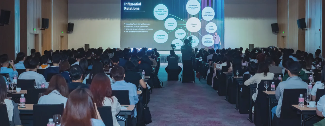 Jon Deragon on stage presenting his keynote speech to attendees at the UXVN Fest 2024 conference.